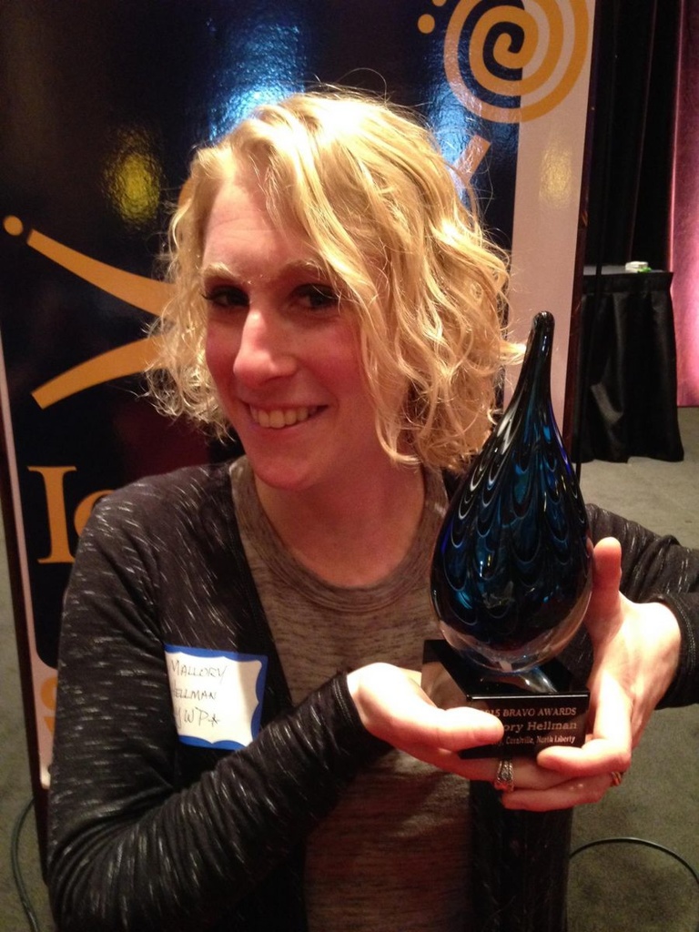 Mal Hellman holds the 2015 Bravo Award that recognizes her service to the Iowa City/Coralville area community.